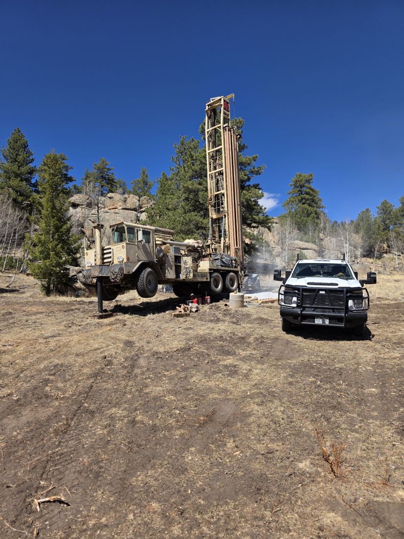 Rig and truck at a forest job site